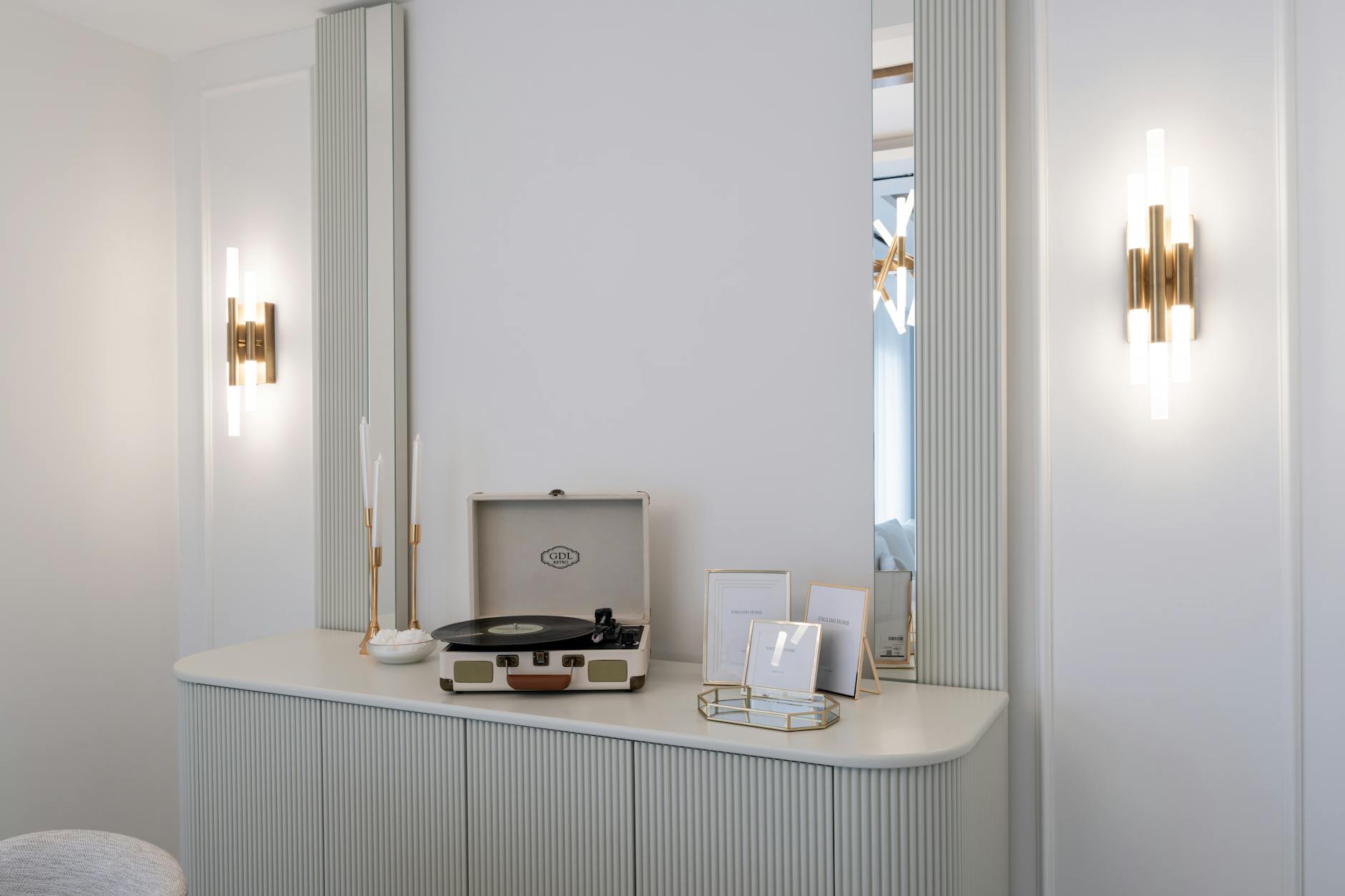 Stylish minimalist interior featuring a vintage vinyl record player on a sleek cabinet with ambient lighting.