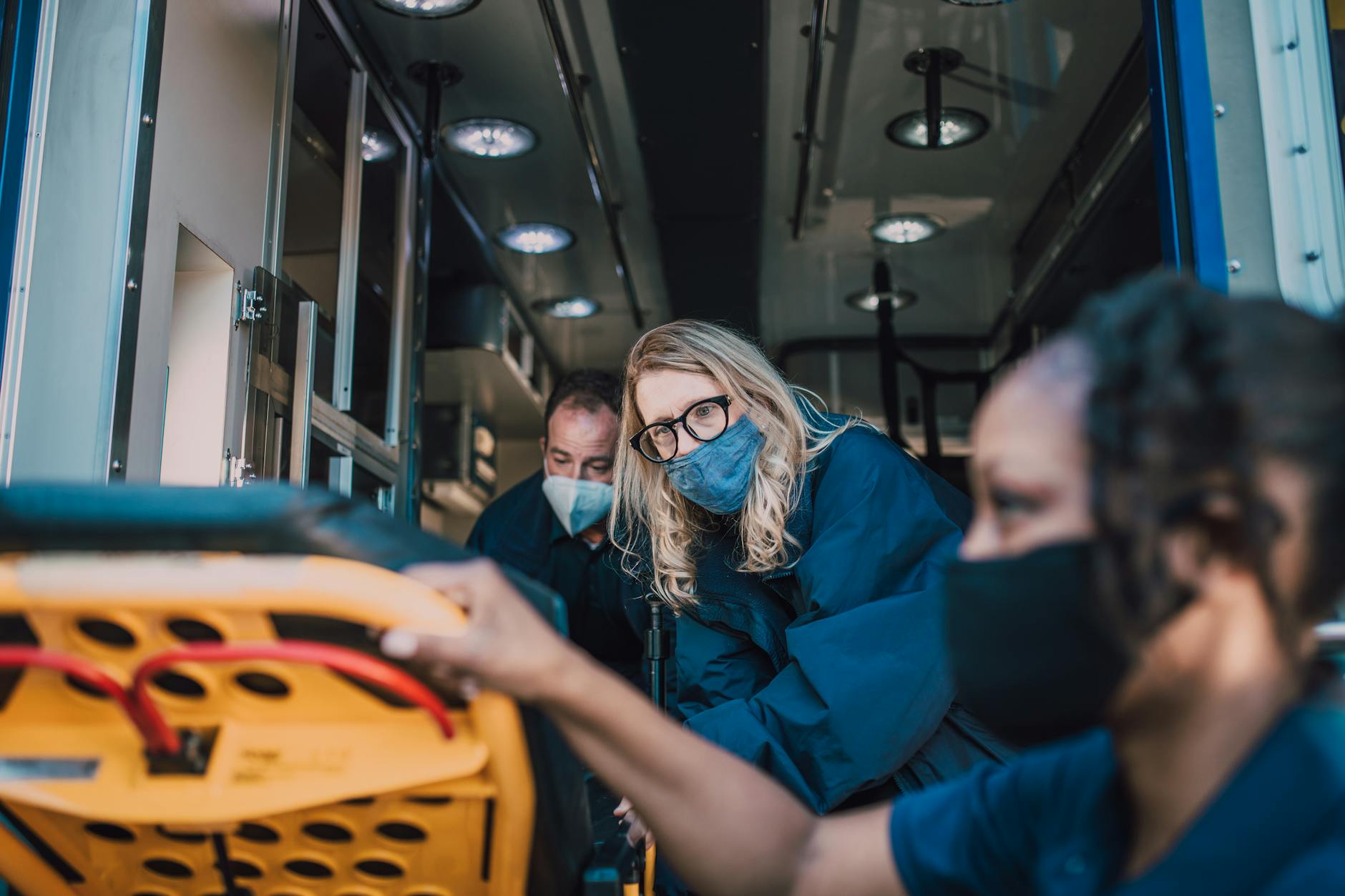 Paramedics attending to a patient inside an ambulance, ensuring immediate care.