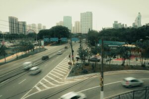 Cityscape of São Bernardo do Campo, Brazil, featuring a busy intersection with skyscrapers and blurred vehicles.